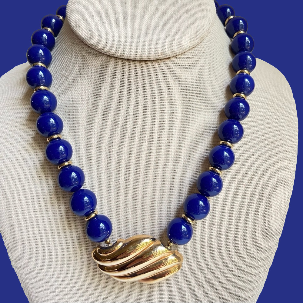 Avon vintage necklace with blue acrylic beads and attached goldtone pendant